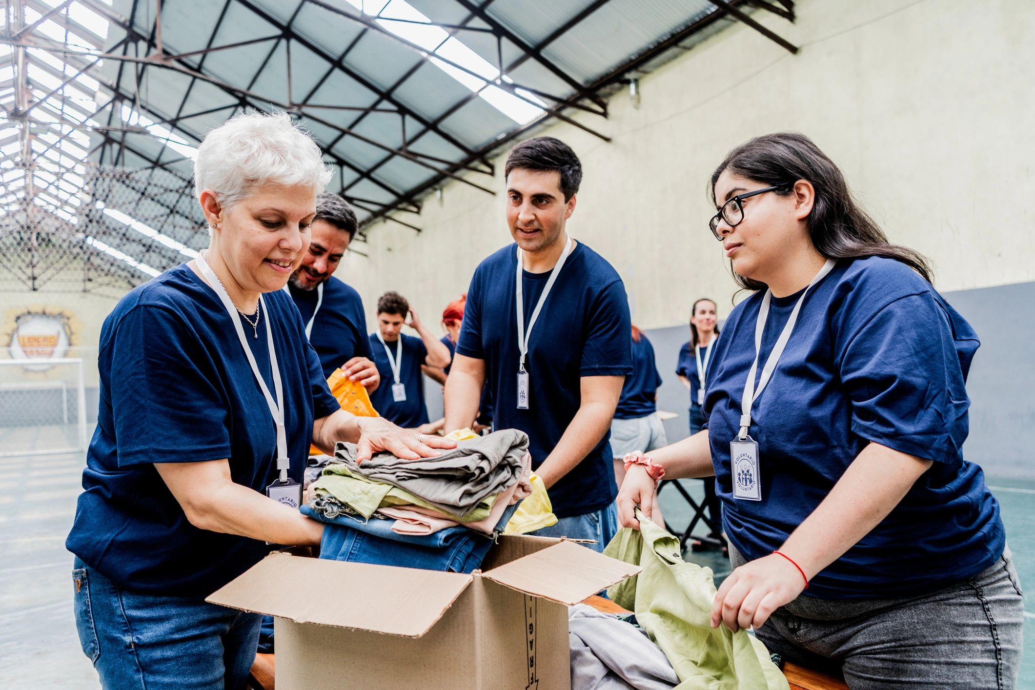 Volunteers sorting donated clothing and boxes