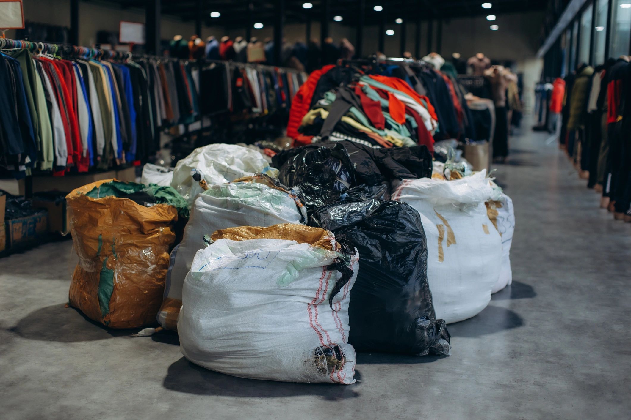 Bags of used clothing ready for sorting