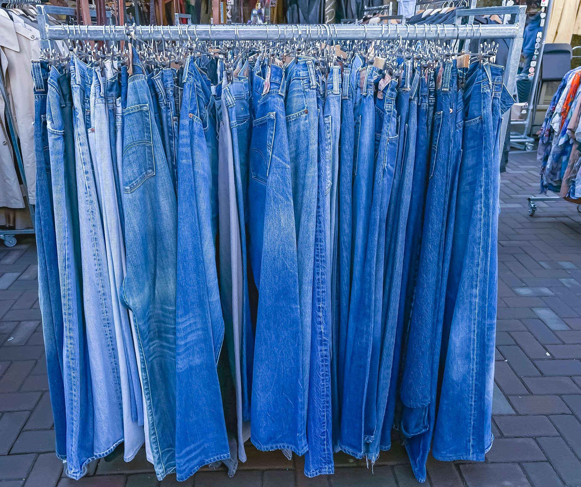 Used denim clothing on a rack